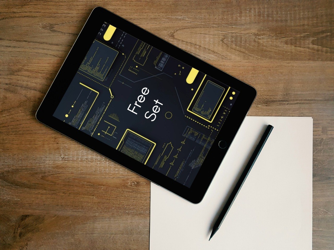 Tablet displaying a design software interface with 'Free Set' text on a wooden surface.